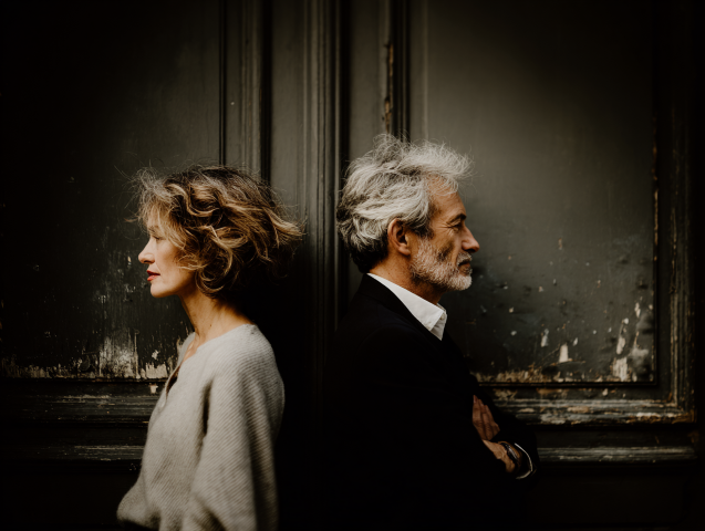 A relatable image of a couple in their 40s/50s, perhaps sitting thoughtfully on a couch or walking together